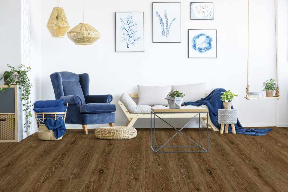 Grecian blue inspired decor in living room with dark wood look luxury vinyl plank